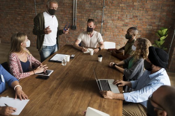 Equipe de trabalho reunida na mesa do escritório
